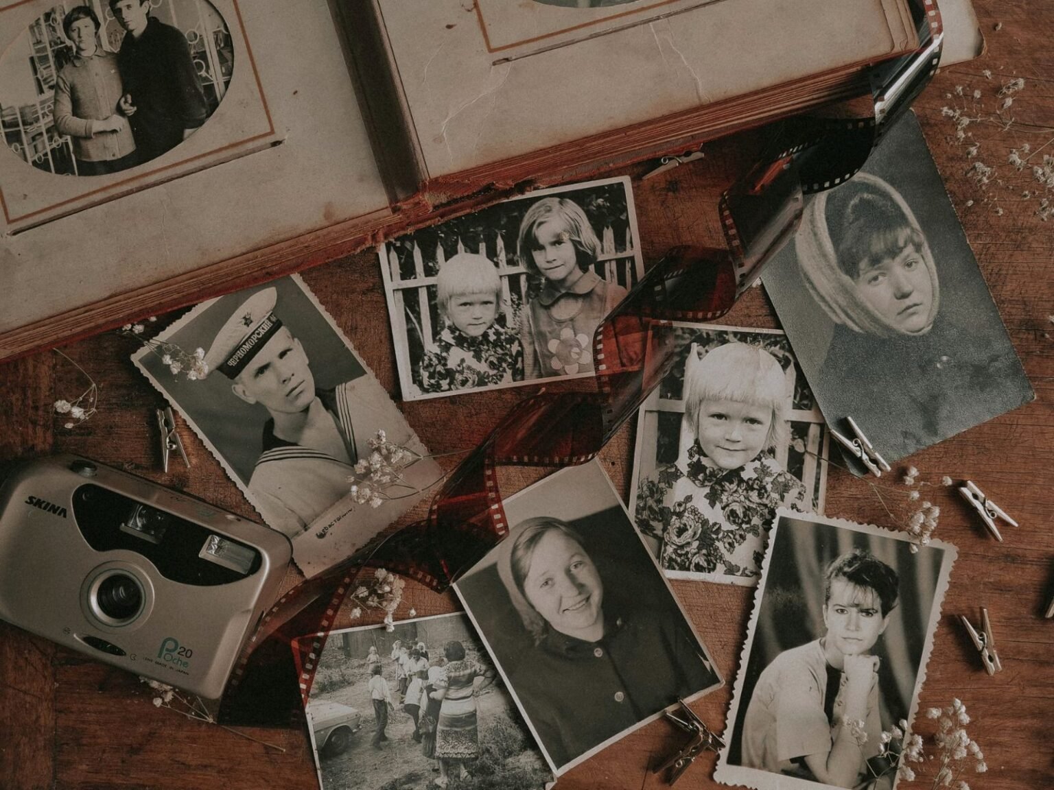 Stare rodzinne fotografie i aparat na drewnianym stole